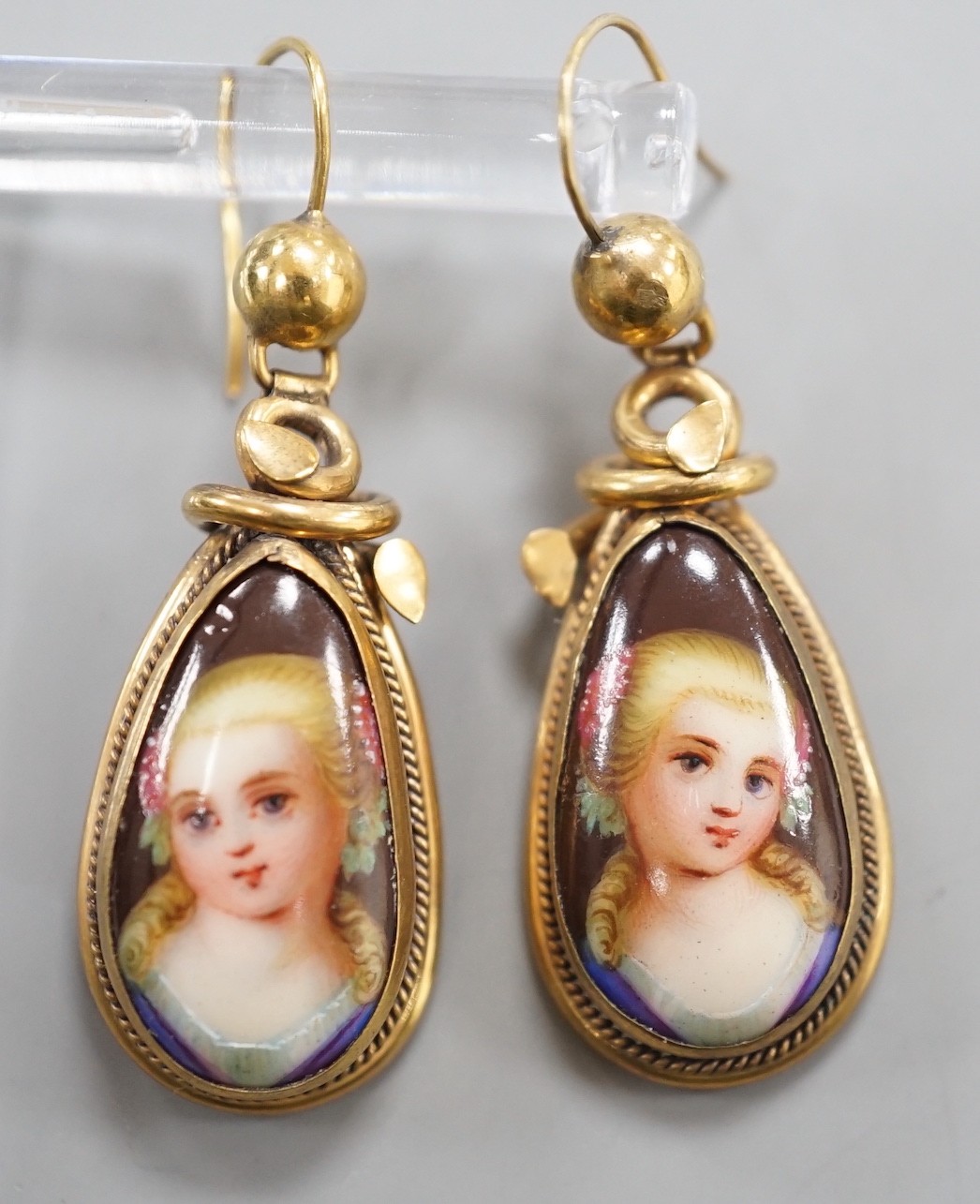 A pair of late Victorian pinchbeck and enamel drop earrings, each decorated with the bust of a lady, 34mm.